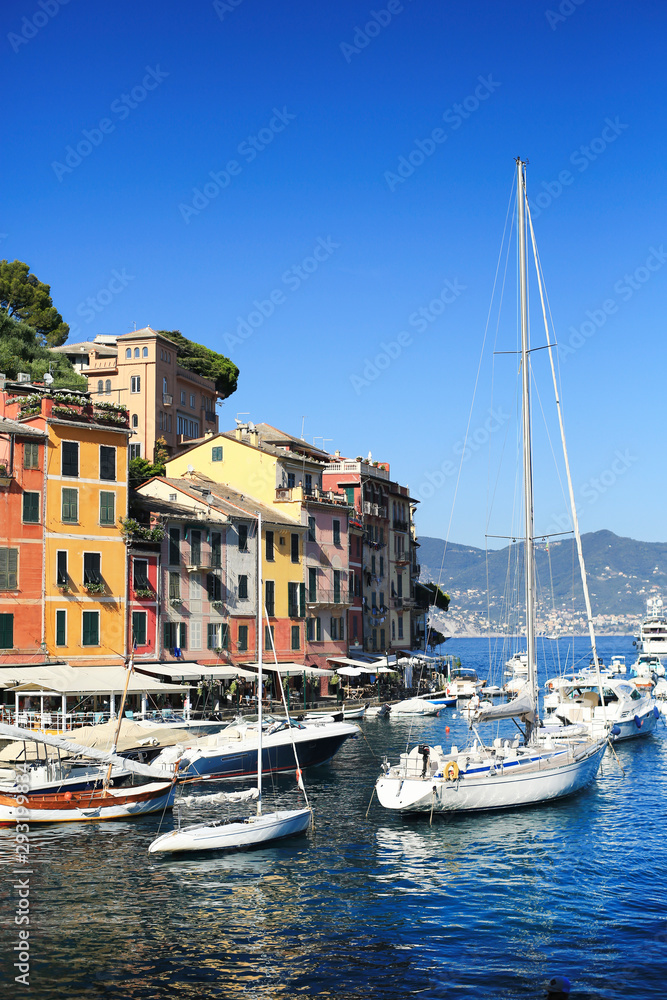 Beautiful promenade with ships and boats in Portofino in Italy