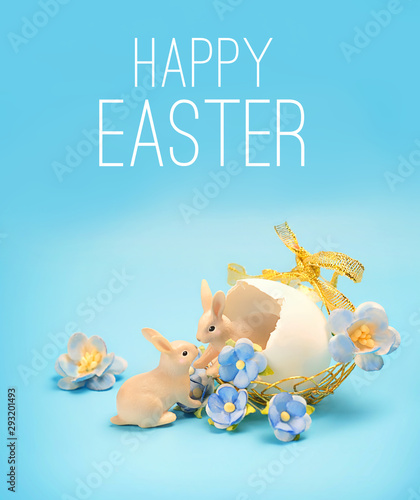 Happy Easter greeting card. cute hares toy and eggs with flowers. Easter holiday background, spring season. Easter decoration with lovely rabbits and eggs, Easter idea, minimalism decor.