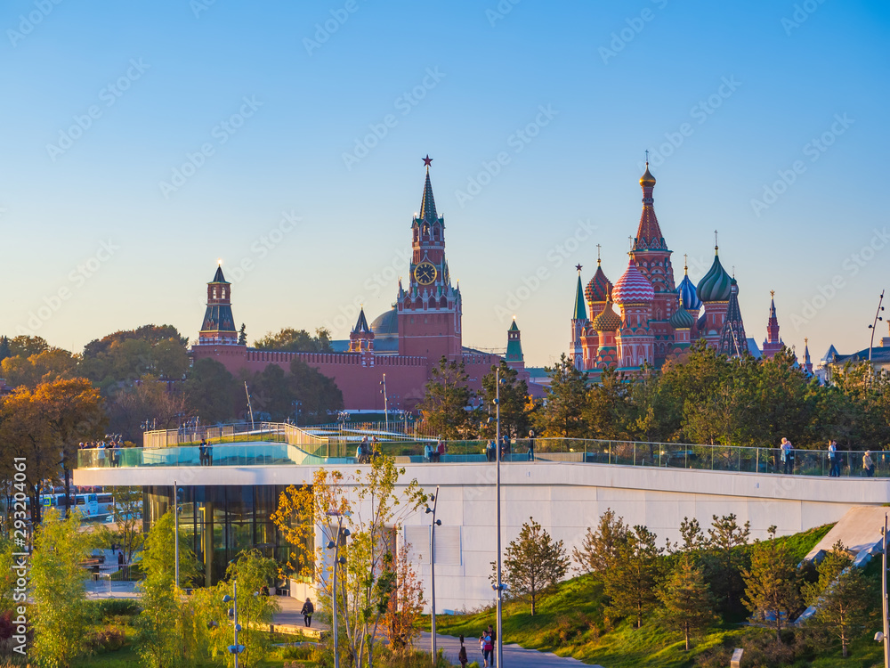 Beautiful view of Zaryadye landscape park with the steeples of the Kremlin and the St Basil`s Cathedral in the background on a sunny autumn evening. Beautiful view of Zaryadye landscape park with the steeples of the Kremlin and the St Basil`s Cathedral in the background on a sunny autumn evening.