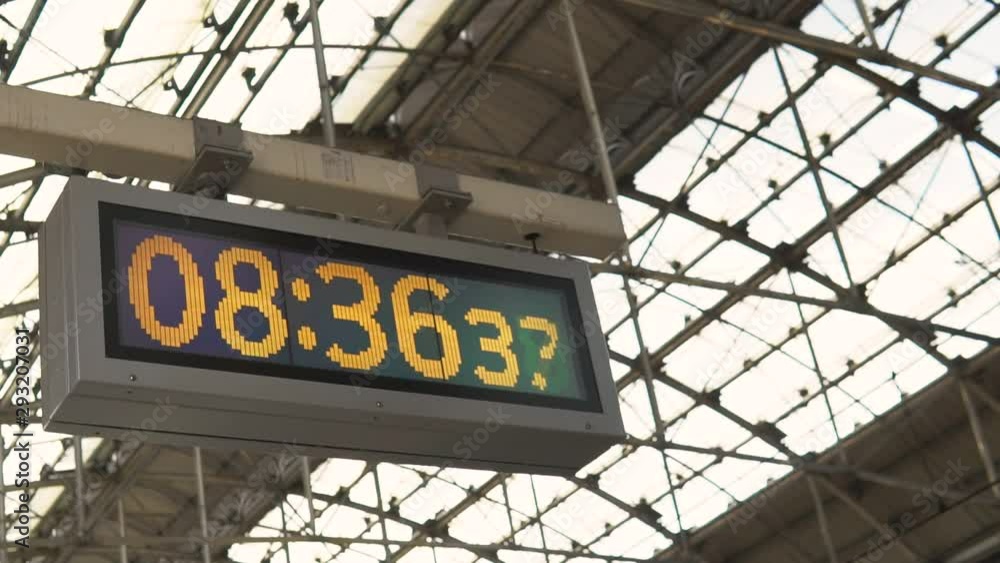 Digital clock at the railway station moving in slow motion. Digital clock at the railway station moving in slow motion.
