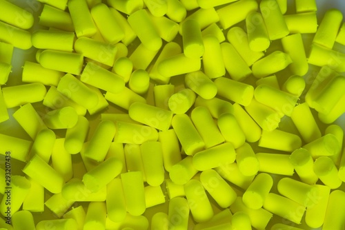 Εκτύπωση καμβά Greenish yellow Disposable earplugs memory foam background.