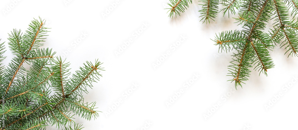 Christmas flat lay, Fir branches decorated with festive balls and Christmas decor on a white mocup background with copy space long banner