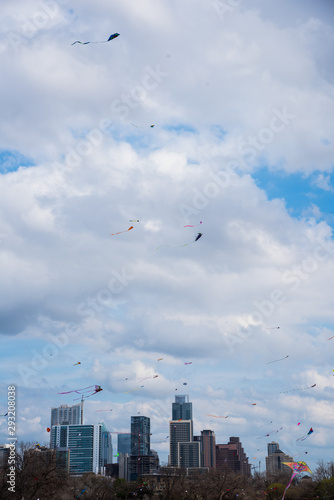 Group of Kites flying in the air against clouds