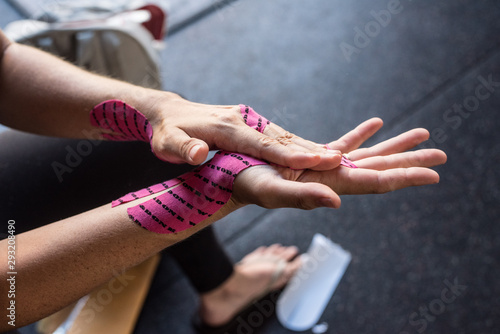 Woman Taping Up Her Hands before Workout