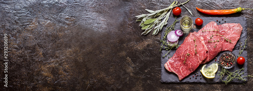 meat beef marbled with spices and herbs on a dark background