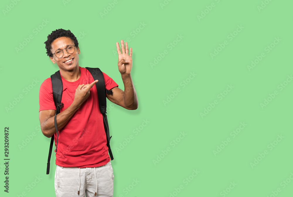 Fototapeta premium Young man making a number four gesture