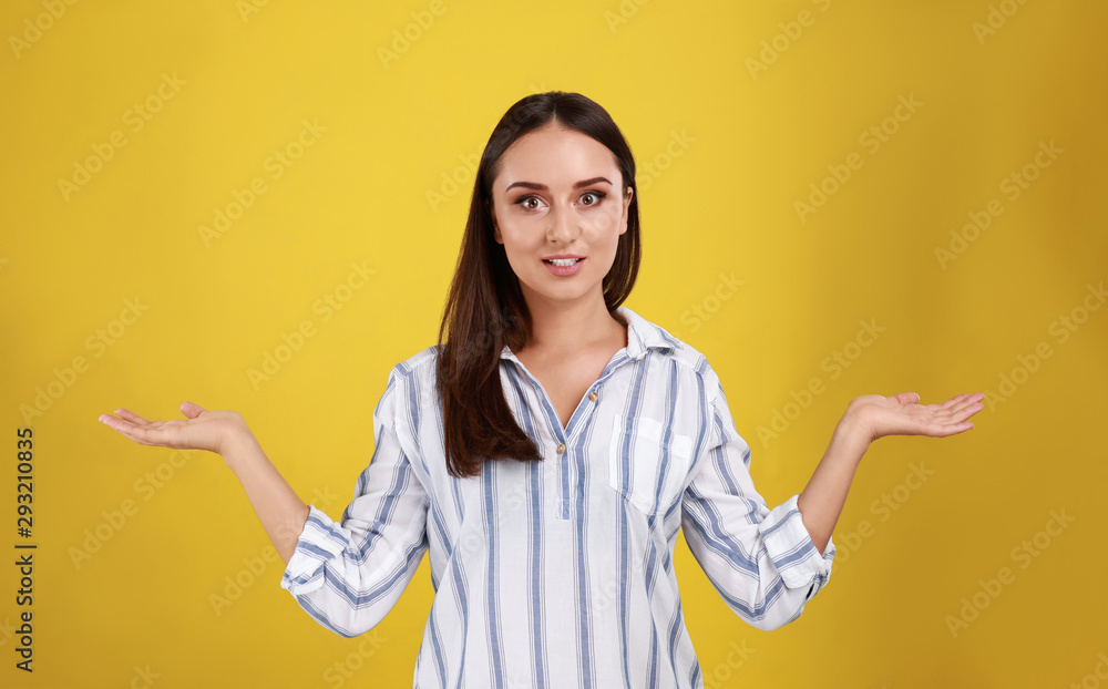 Emotional young woman in casual outfit on yellow background Emotional young woman in casual outfit on yellow background
