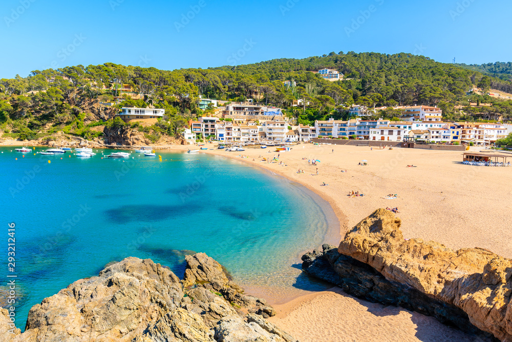 View of Sa Riera beach and fishing village in background, Costa Brava, Catalonia, Spain