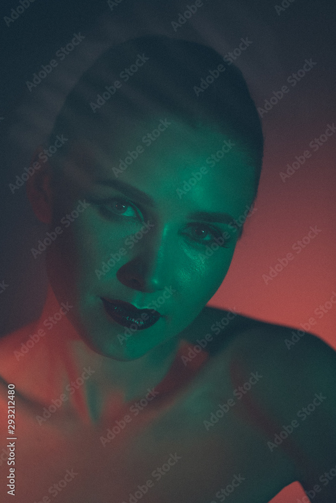 Stunning makeup on the face of a beautiful young girl, beauty makeup, oil on the face and sparkles green with red color will take priority Stunning makeup on the face of a beautiful young girl, beauty makeup, oil on the face and sparkles green with red color will take priority