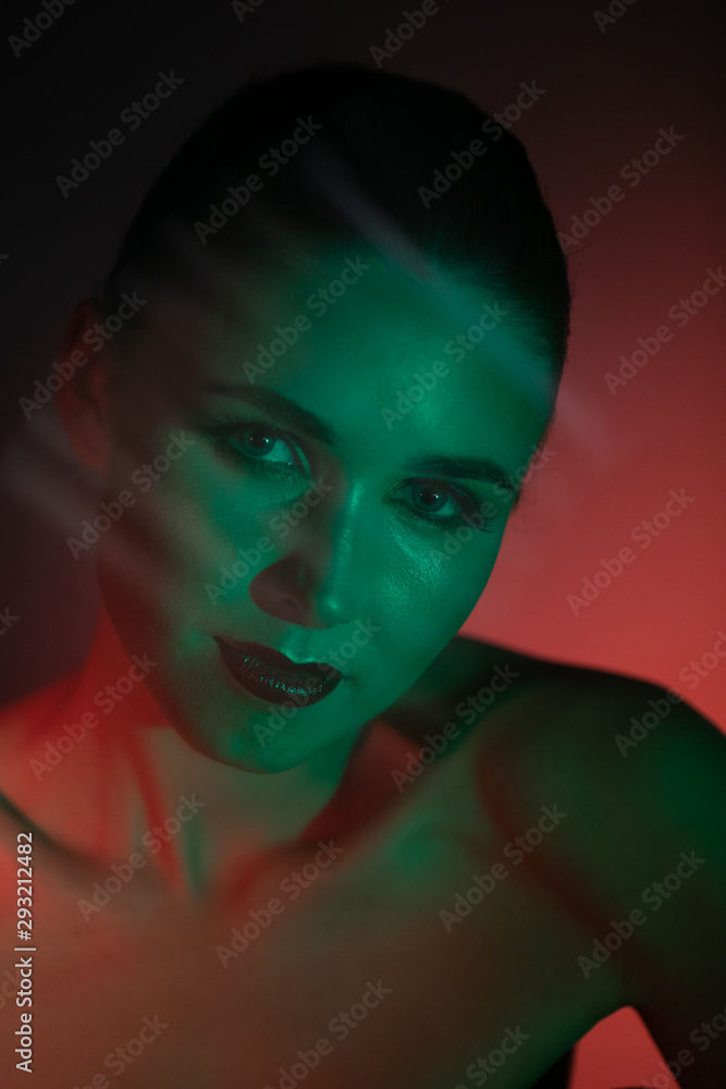 Stunning makeup on the face of a beautiful young girl, beauty makeup, oil on the face and sparkles green with red color will take priority Stunning makeup on the face of a beautiful young girl, beauty makeup, oil on the face and sparkles green with red color will take priority