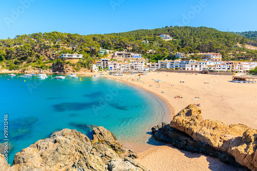 View of Sa Riera beach and fishing village in background, Costa Brava, Catalonia, Spain