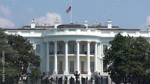 Flag at half staff on the White House waves in the summer breeze in Washington DC