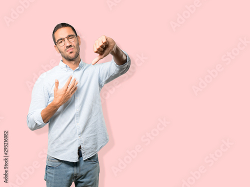 Serious young man doing a gesture of defeated