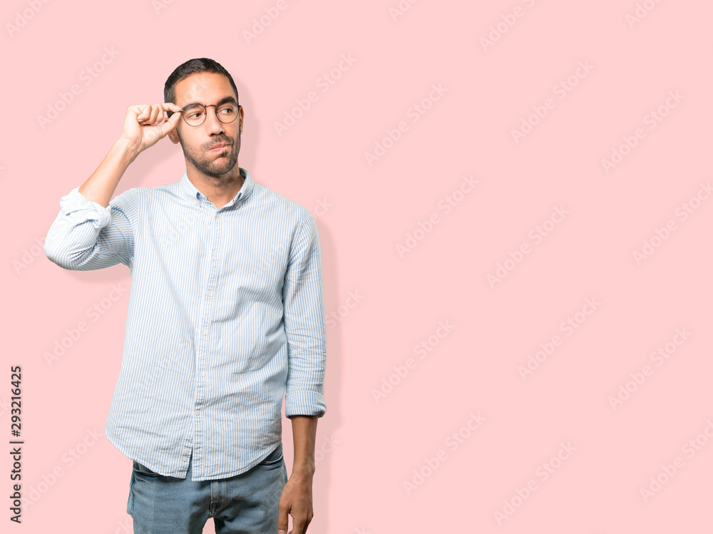 Fototapeta premium Concerned young man doing a gesture of relief