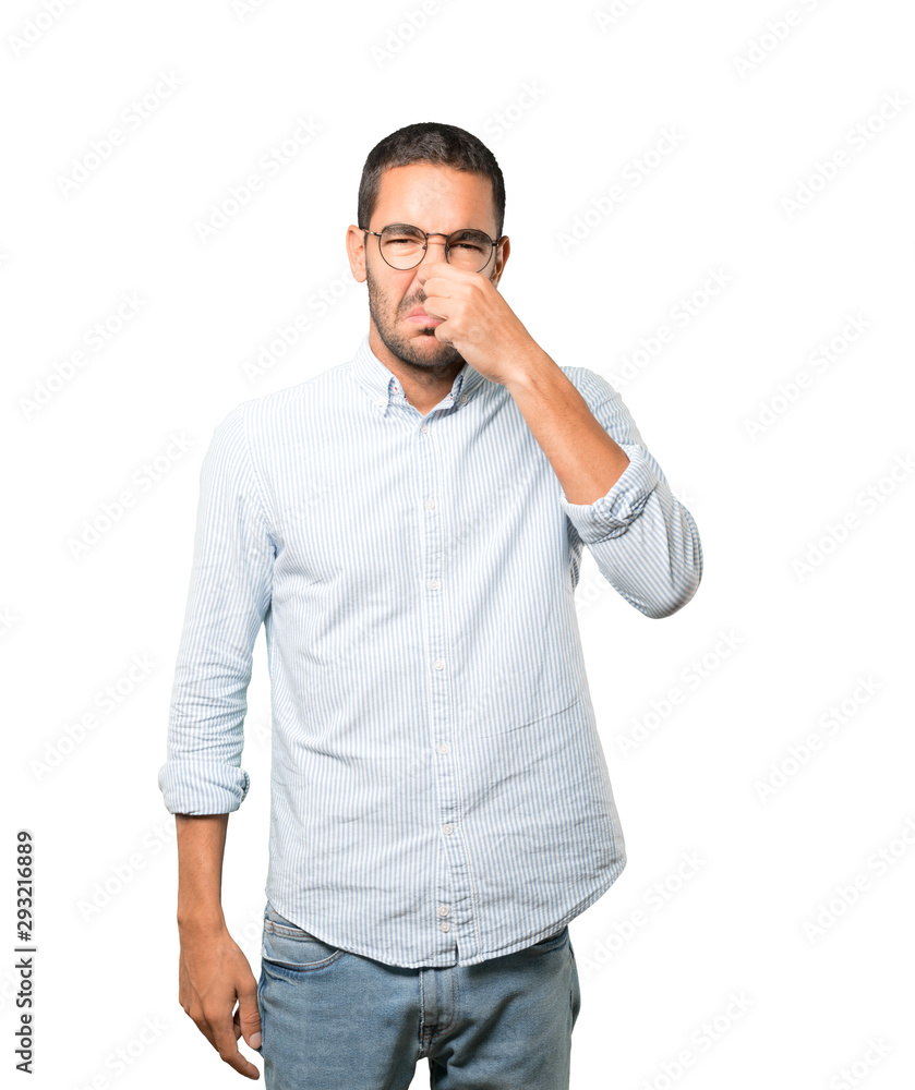 Concerned young man with a gesture of disgust Concerned young man with a gesture of disgust