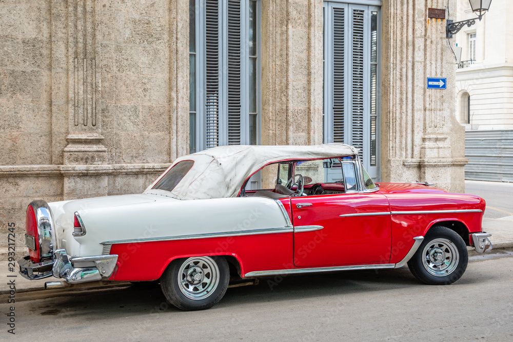 Old red and white cabriolet retro car in the center of Havana, Cuba
