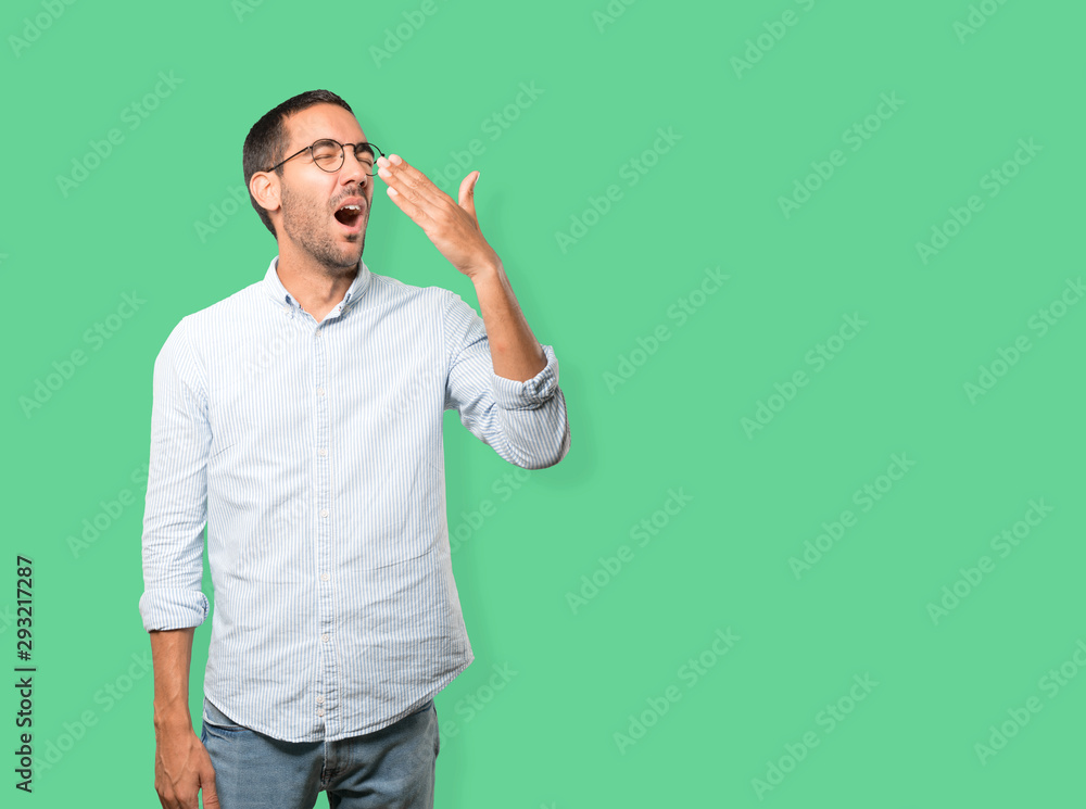 Bored young man yawning gesture Bored young man yawning gesture