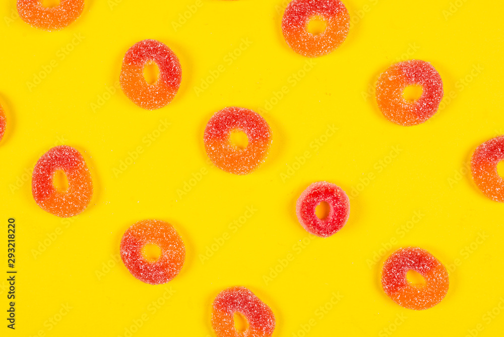 Jelly sweets rings on yellow background. Pattern. Jelly sweets rings on yellow background. Pattern.