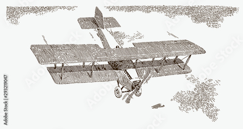 Historical biplane in top view flying over water surface