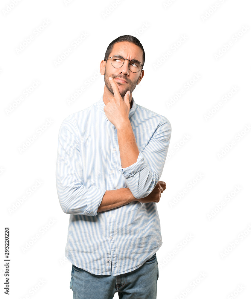 Concerned young man making a gesture of doubt Concerned young man making a gesture of doubt