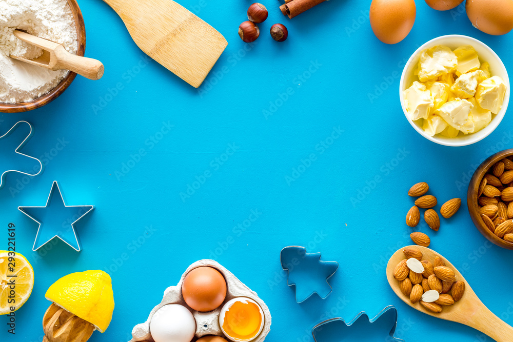 Cooking for Christmas or New Year dinner. Baking frame. Ingredients and utensil on blue background top view copy space