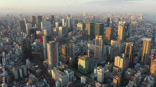 Aerial view over Osaka city with many skyscrapers in the morning. Osaka is the capital city of Osaka Prefecture, the second largest metropolitan area in Japan.