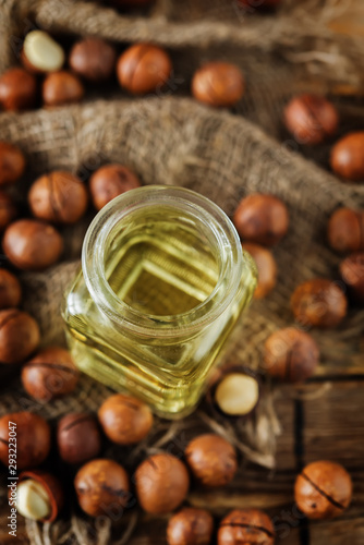 macadamia oil in glass with macadamia nuts