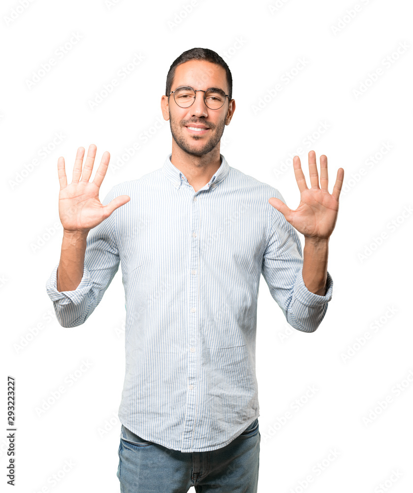 Young man making a number ten gesture Young man making a number ten gesture