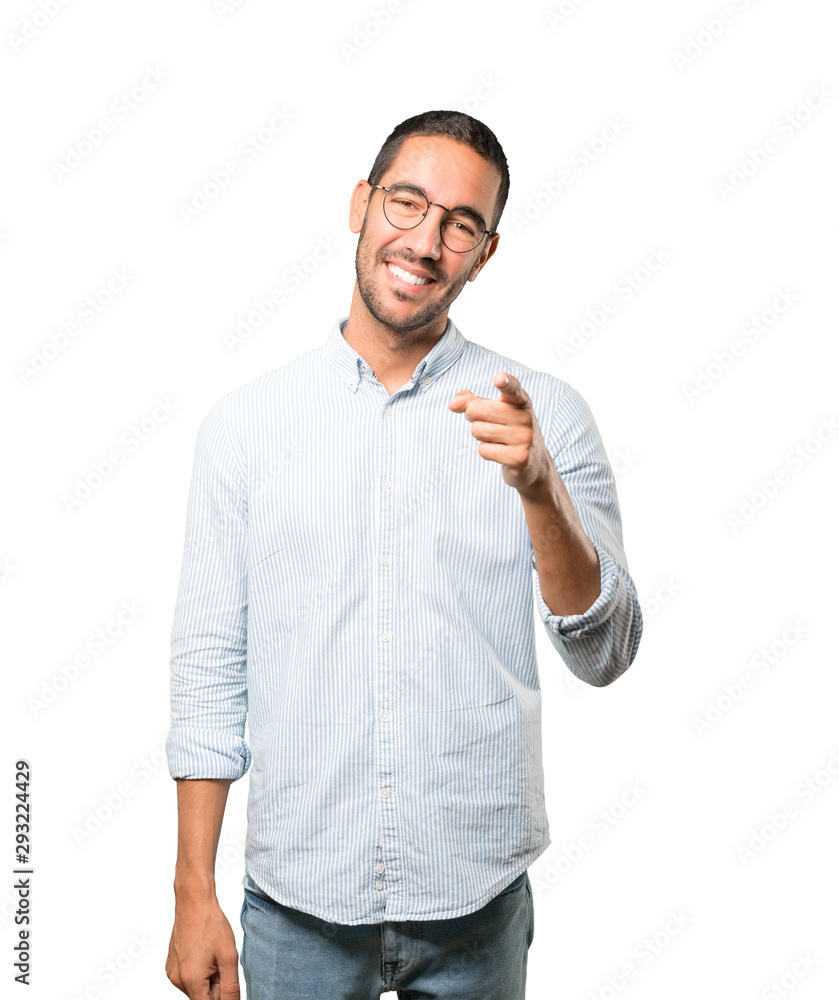 Happy young man pointing at you with his finger Happy young man pointing at you with his finger