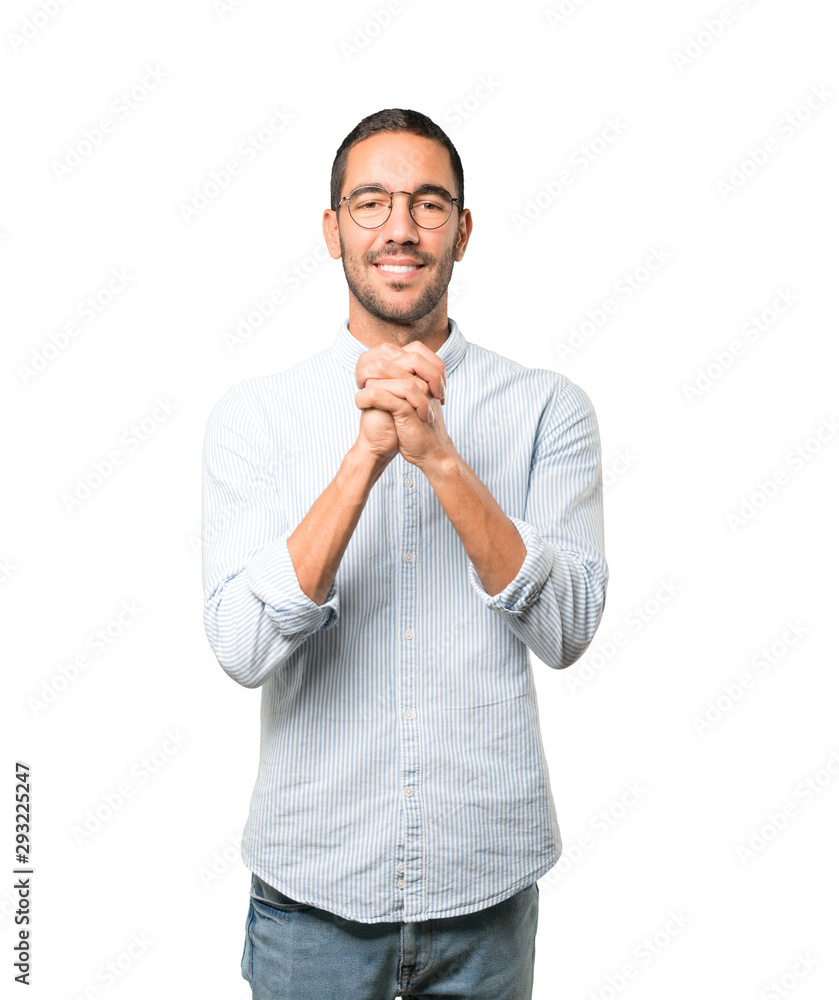 Young man making a gesture of team work with his hands Young man making a gesture of team work with his hands