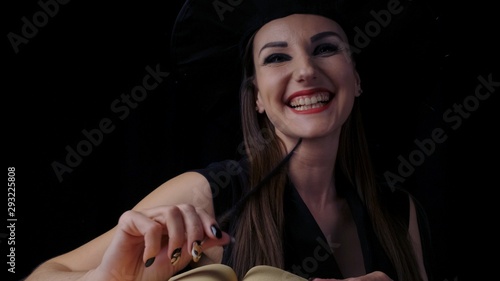 Wallpaper Mural Attractive female witch with bright red lips with an open book of spells, smiles, conjures with the help of mechanical spiders and cobwebs. Torontodigital.ca