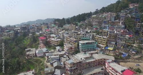 Multi-story buildings and dwellings in Dharmasala, India. Aerial flyover. photo