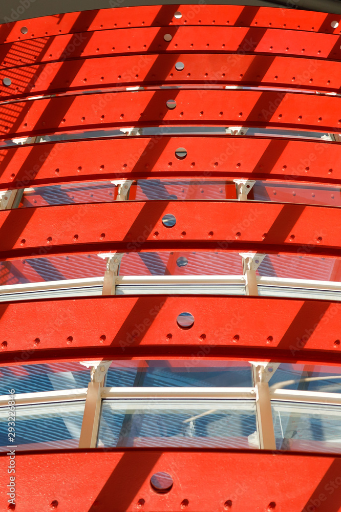 Bent metal structures painted with bright red paint. Illustration of color and design application in modern industry.