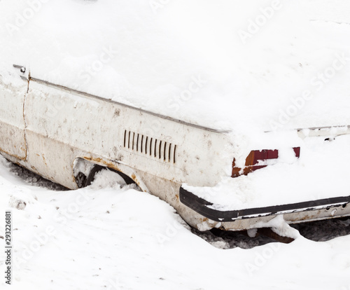 Car in the snowdrift on the parking lot photo