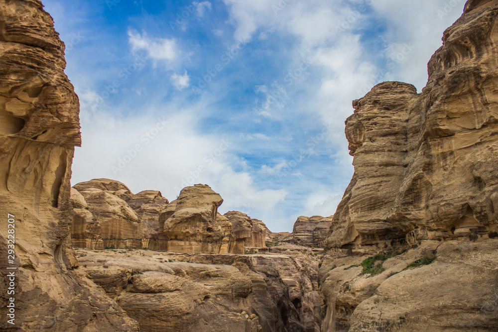 rocky canyon sand stone mountains natural shapes Middle East Israeli scenery landscape view with blue sky white clouds background 