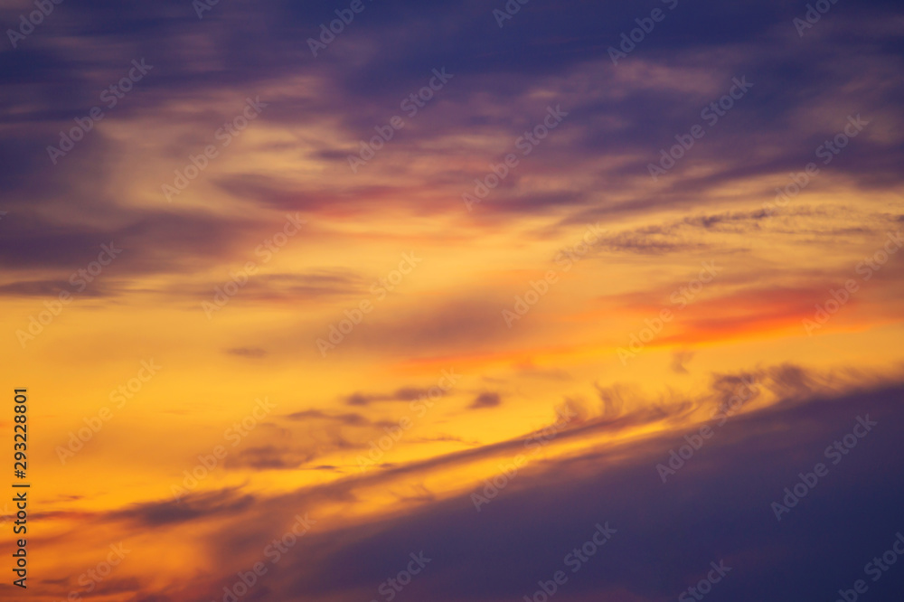 Beautiful stormy sunset sky. Cloudy abstract background. Sunset colors. Blurred shot of the dramatic sunset