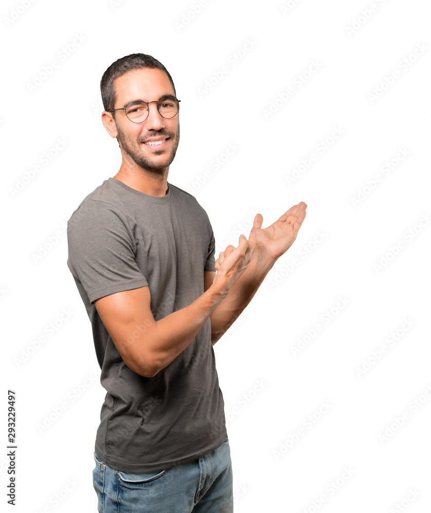 Friendly young man making a gesture of welcome Friendly young man making a gesture of welcome