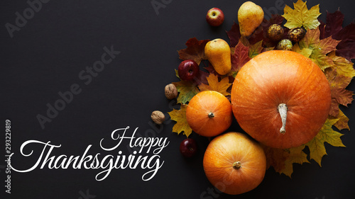 Happy Thanksgiving background. Pumpkins with fruits, vegetables, walnuts and falling leaves. Autumn, fall, halloween concept. Flat lay