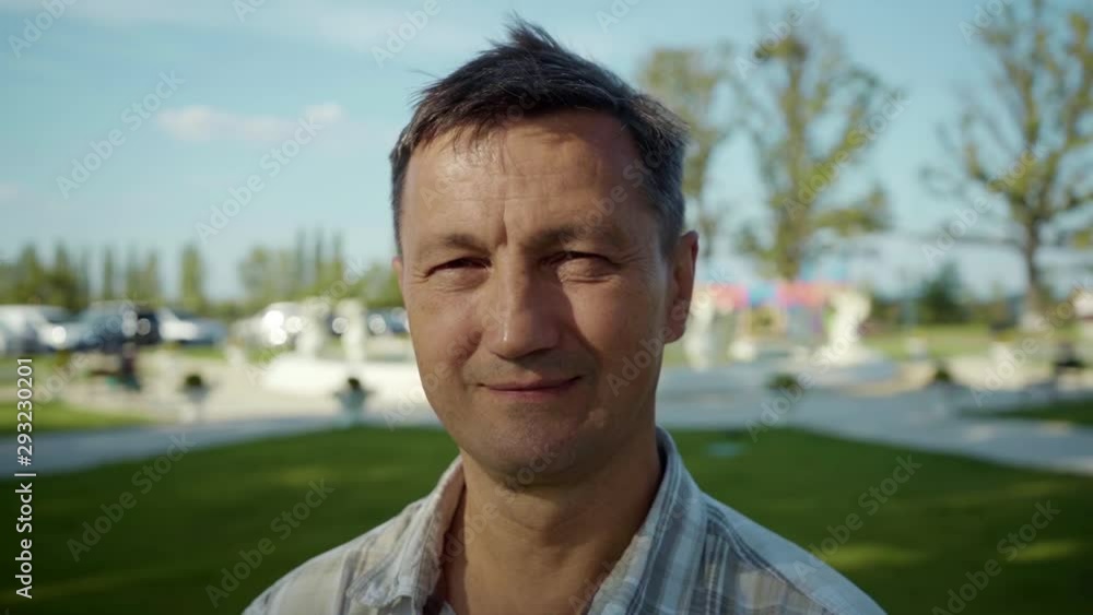 Shot of handsome man look at camera smile feel happy summer elderly face outdoor footage travel rest silhouette sky sun sunset portrait close up slow motion Shot of handsome man look at camera smile feel happy summer elderly face outdoor footage travel rest silhouette sky sun sunset portrait close up slow motion