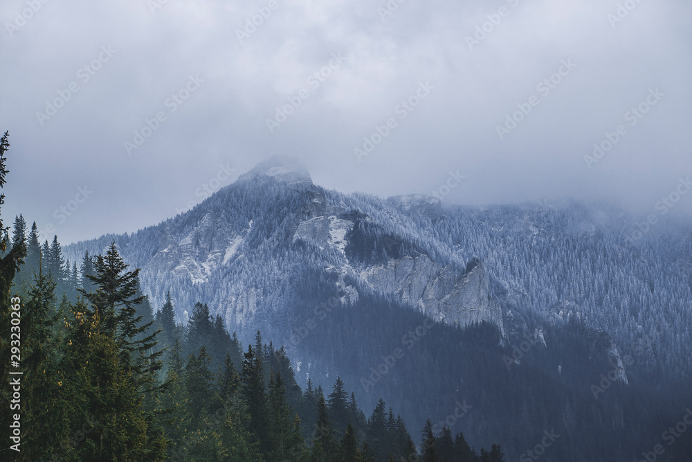 Frozen mountain in winter clouds