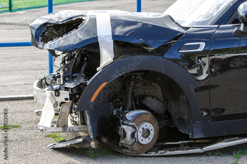 The body of the car is damaged as a result of an accident. High speed head on a car traffic accident. Dents on the car body after a collision on the highway