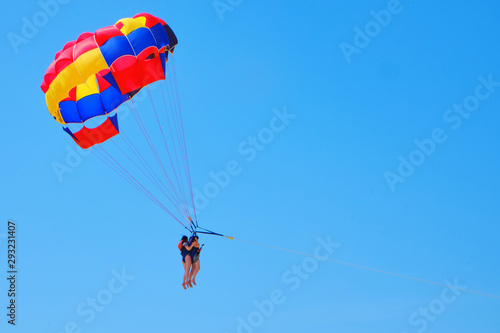Tandem skydivers against the blue sky - two women in tandem