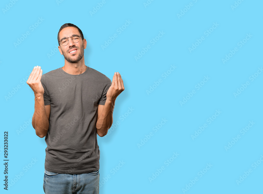Confused young man making an italian gesture of not understand Confused young man making an italian gesture of not understand