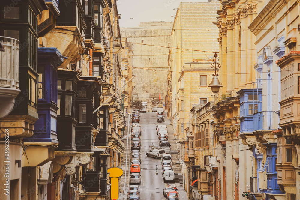 Old Narrow Street With Traditional Closed Wooden Balconies In Valletta city, Malta