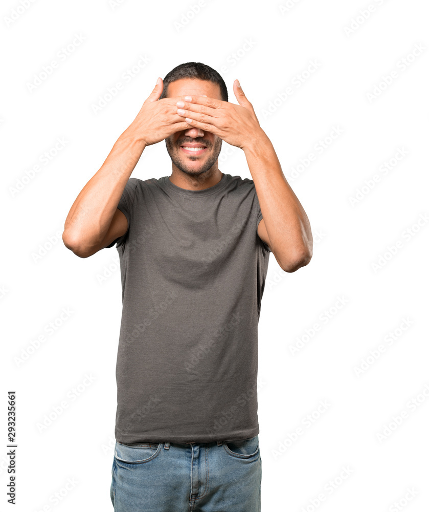 Young man covering his eyes with his hands Young man covering his eyes with his hands