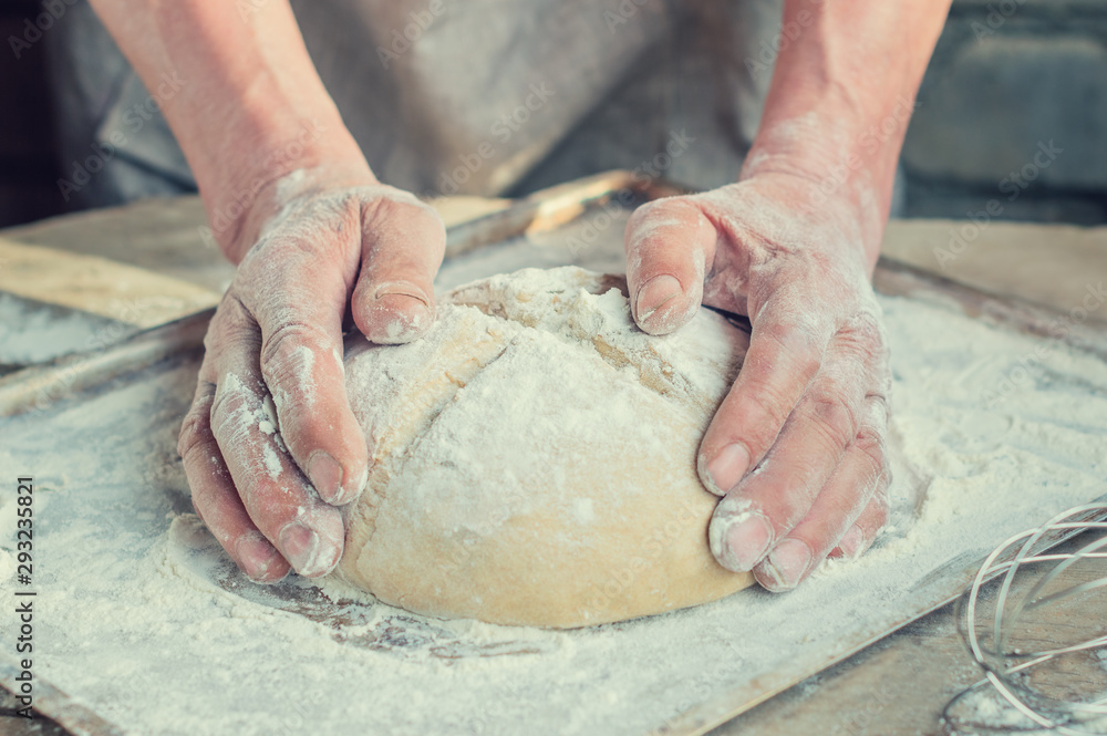The Baker's hands. Process the dough for wheat bread. Rustic style.