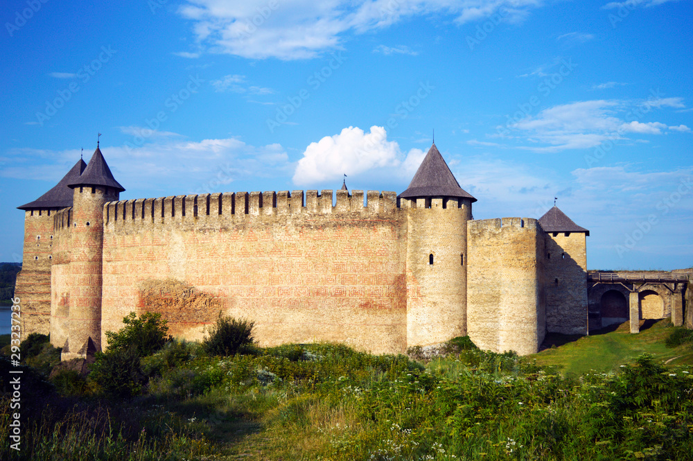 Wall of ancient stone castle with many hight towers in Khotyn, Ukraine on July 19, 2018. 
