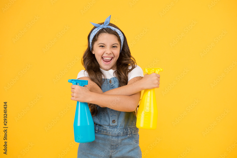 Domestic cleaning for you. Happy domestic helper on yellow background. Cute little girl hold spray bottles for domestic help. Maintaining domestic household Domestic cleaning for you. Happy domestic helper on yellow background. Cute little girl hold spray bottles for domestic help. Maintaining domestic household