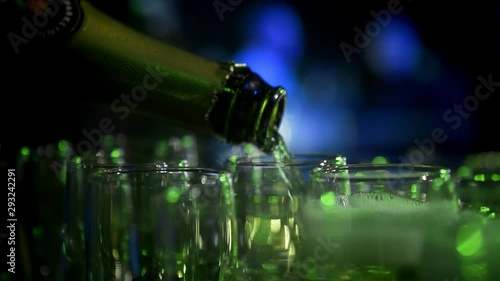 champagne is poured into glasses in slow motion