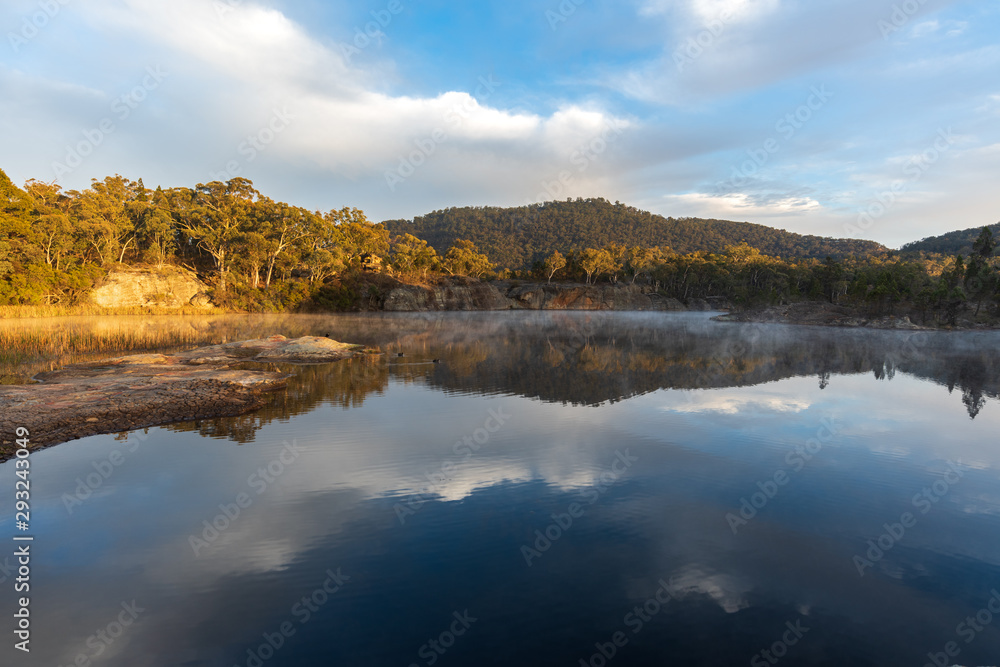 Fototapeta premium Sunrise at Dunn's Swamp. Australia outback sunrise with mist on the water.